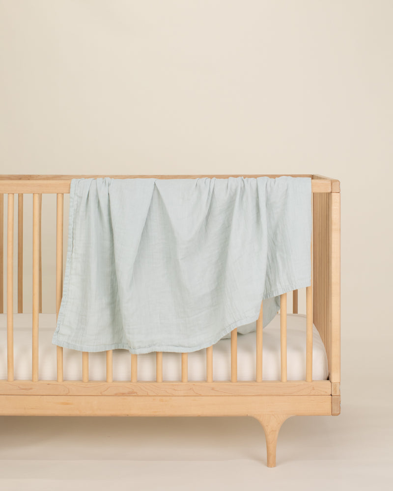 aqua organic cotton gauze swaddle on crib