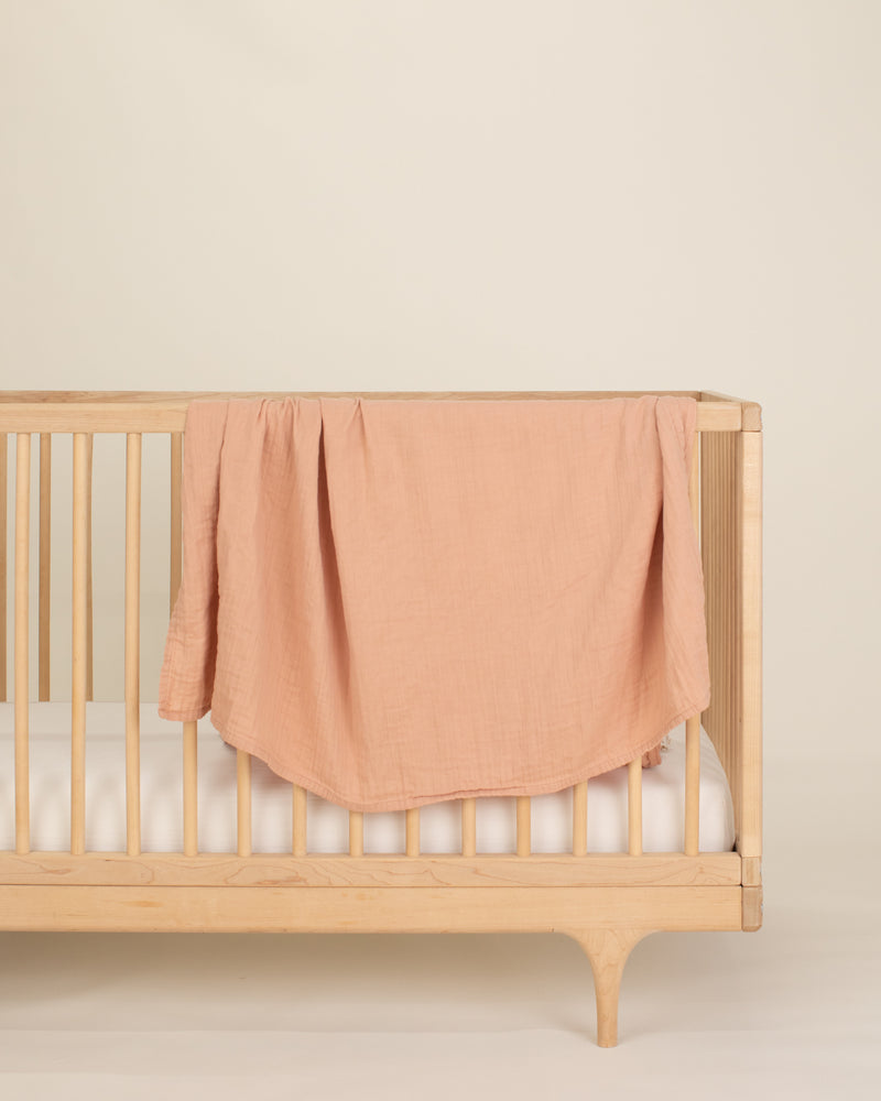 nude organic cotton gauze swaddle on crib