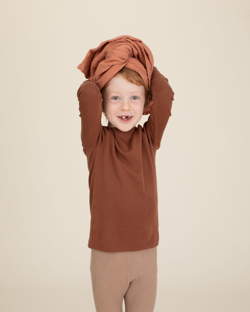 rust organic cotton gauze swaddle on head