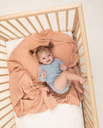 nude organic cotton swaddle in crib