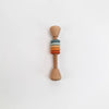 Wooden rattle with colorful rings on a white background