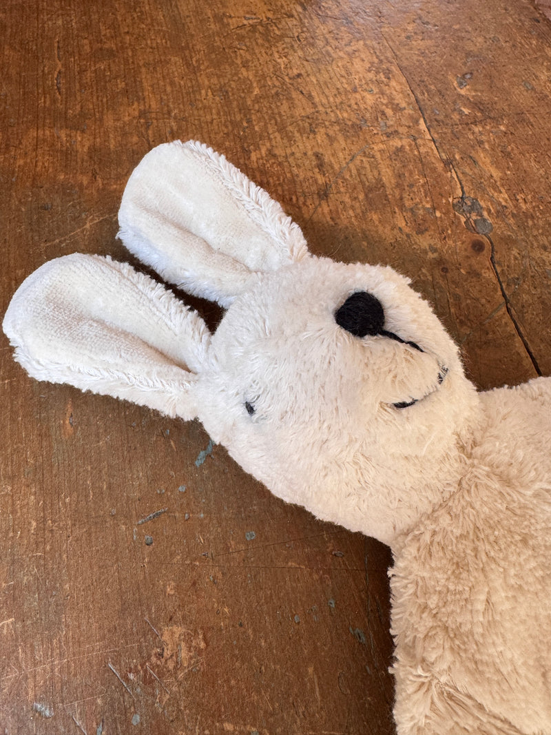 Plush bunny toy on a wooden floor