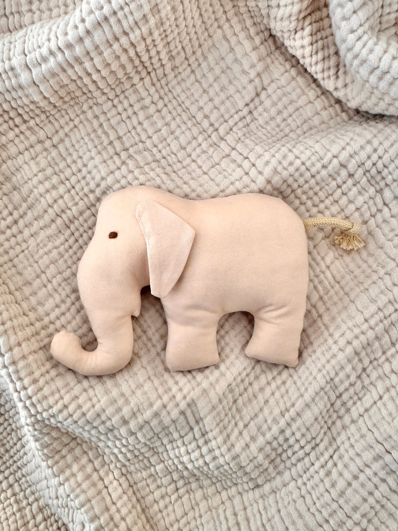 Stuffed elephant toy on a textured blanket
