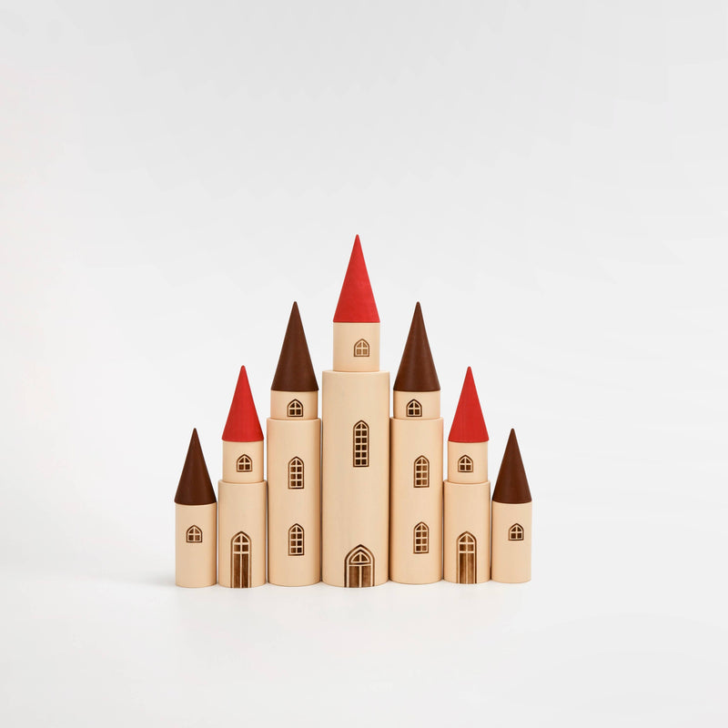 Wooden toy castle with red rooftops on a white background