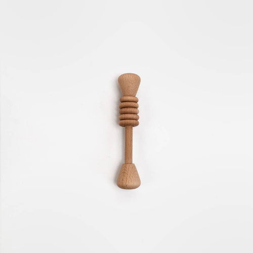 Wooden baby rattle on a white background