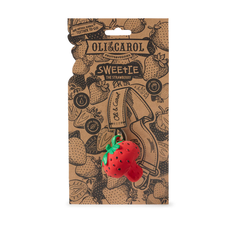 Strawberry-shaped toy on a branded packaging with 'Oli & Carol' and 'Sweetie' text.