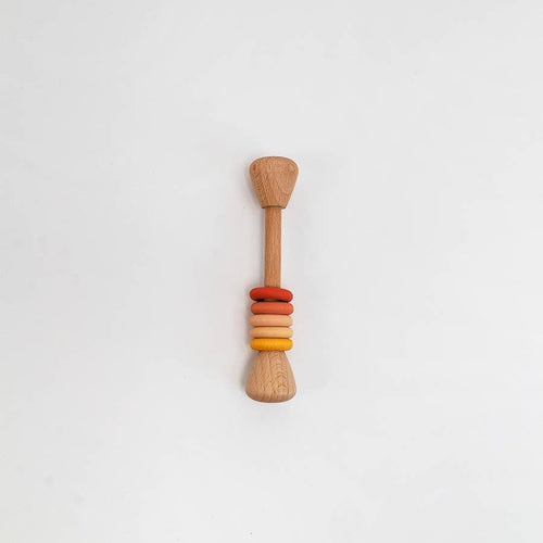 A wooden baby teether or sensory toy with a natural wood handle and colorful stacked beads in red, orange, and yellow, centered on a plain white background.