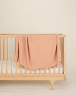 nude organic cotton gauze swaddle on crib