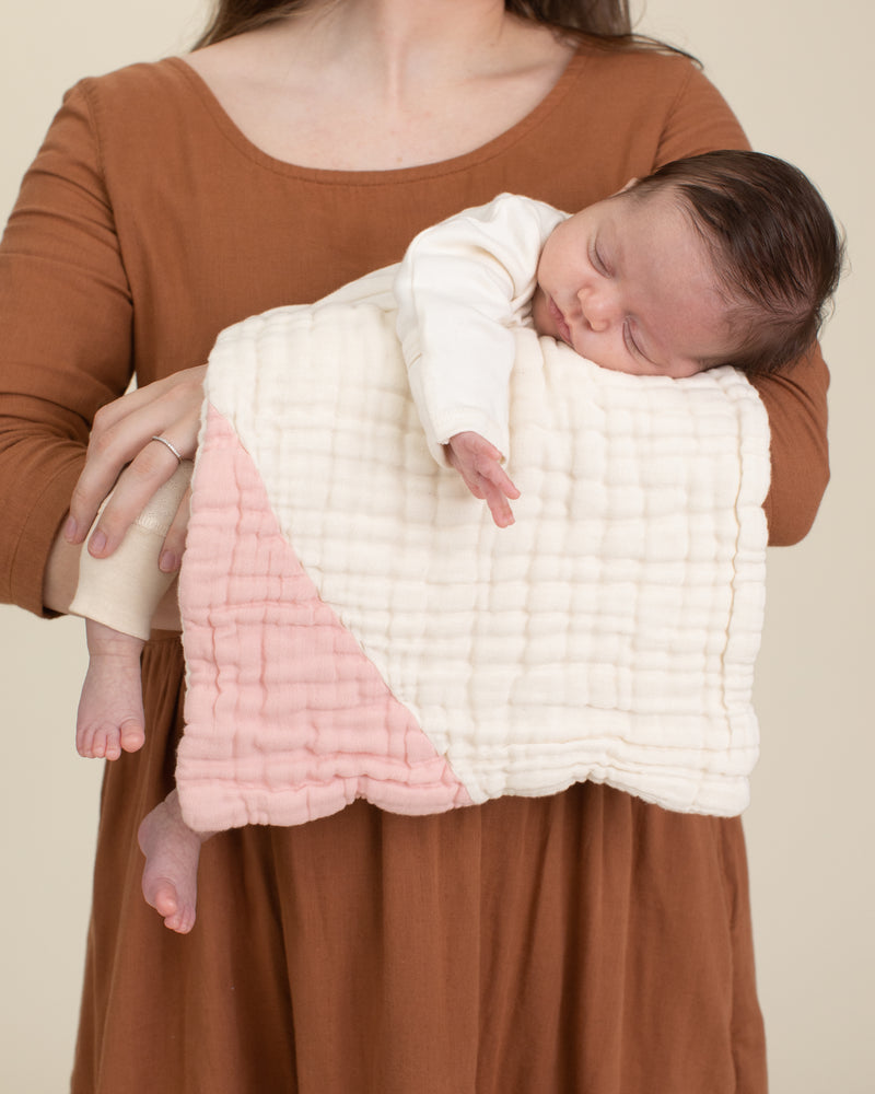 mother and baby with light pink organic cotton gauze geo burp cloth