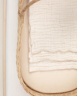 white organic gauze burp cloths in basket